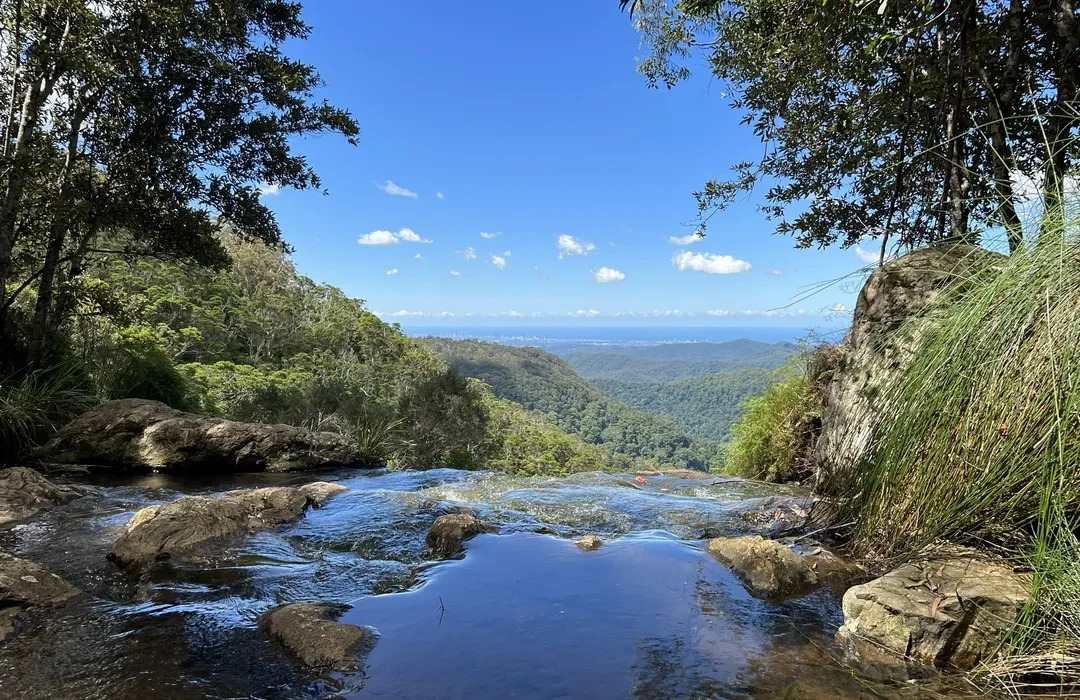 getaways-gold-coast natural infinity pool overlooking rainforest and coastline at springbrook national park, a scenic spot popular for peaceful getaways gold coast
